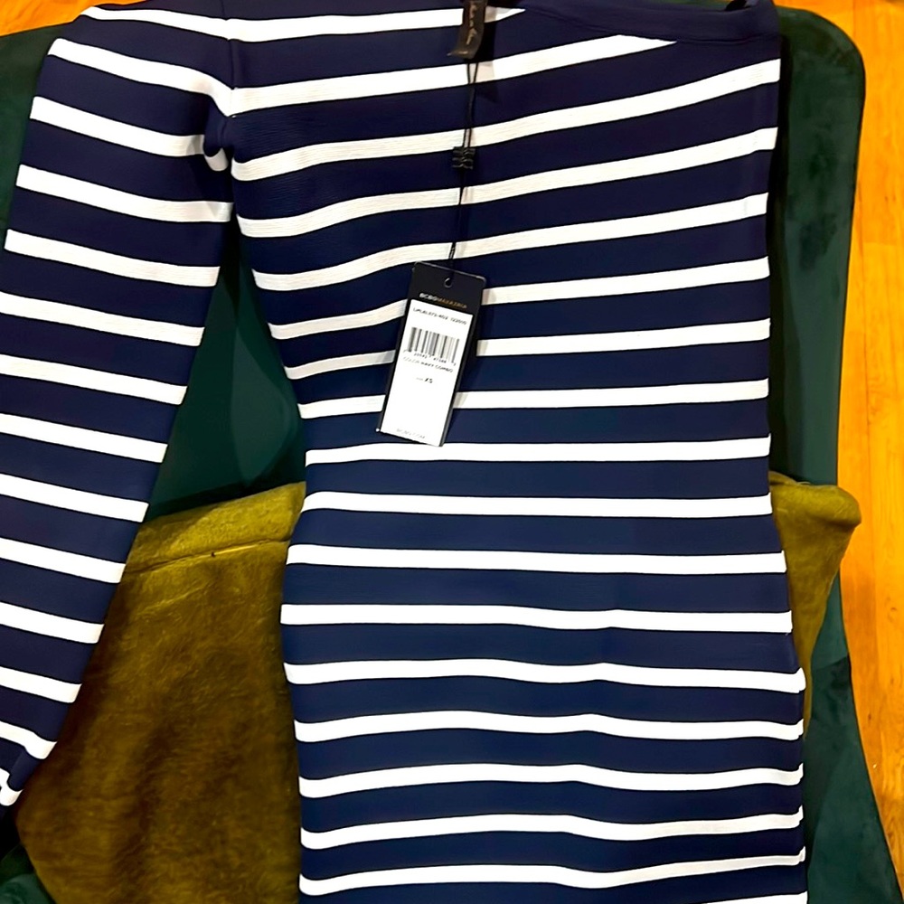 Navy and white one shoulder dress. With a pop of orange
